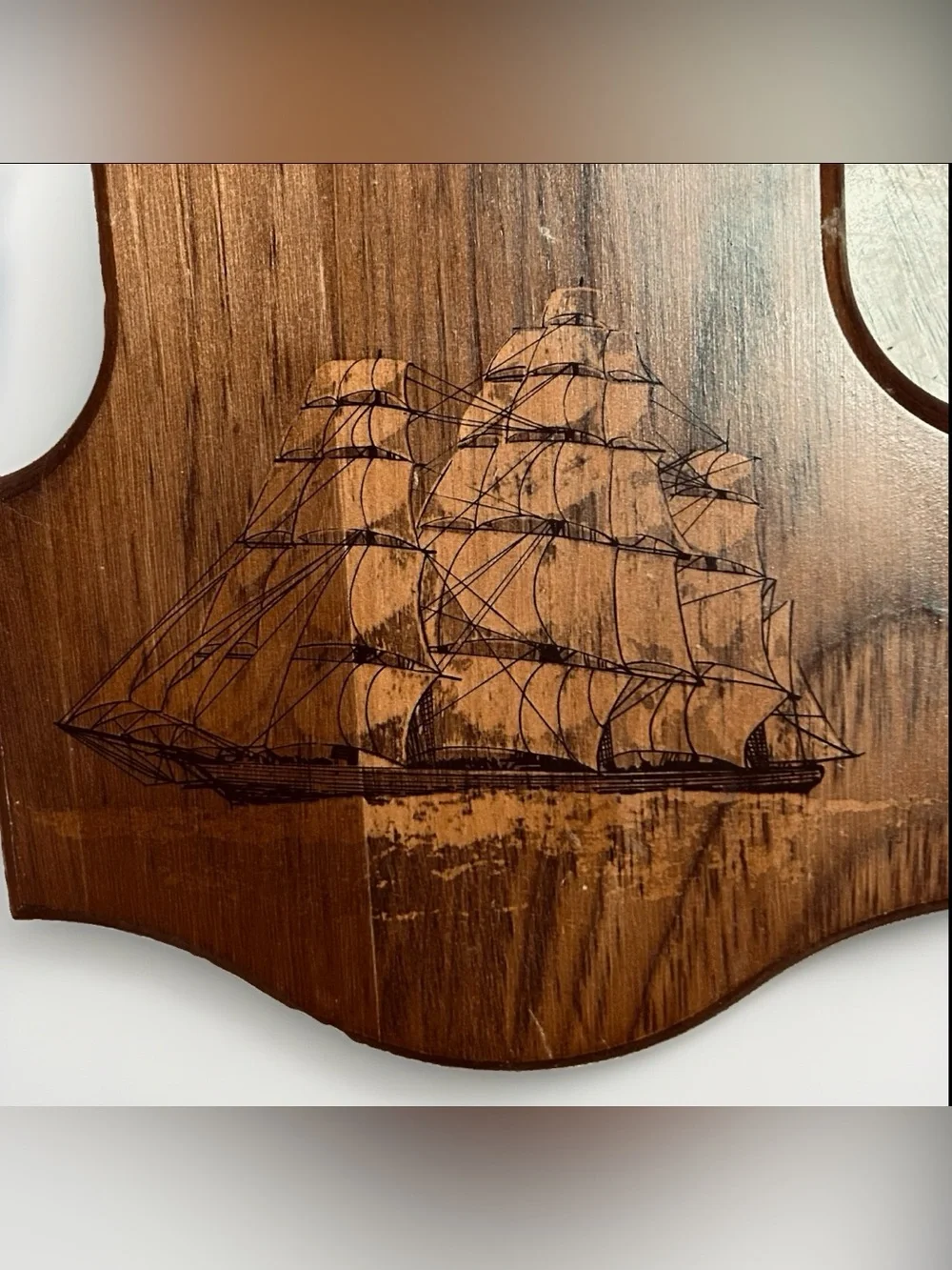 Bulova wall clock features a unique wooden casing shaped like a stylized ship